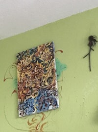 a painting on the wall of a room with a spider on it