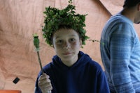 a boy wearing a green crown